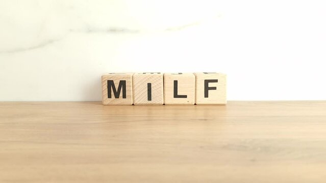 Word milf made from wooden blocks. Sexuality, erotic concept