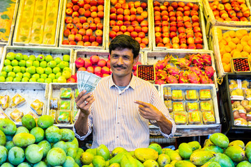 Fruit shop - Indian male street vendor selling fresh fruits