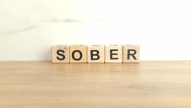 Word sober made from wooden blocks. Quitting alcohol addiction concept