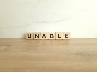 Word unable made from wooden blocks