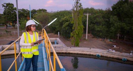 Fototapeta premium Environmental engineers work at wastewater treatment plants,Water supply engineering working at Water recycling plant for reuse,Check the amount of chlorine in the water to be within the criteria.