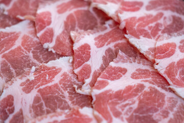 Close up of sliced raw meat, ready to be cooked by hot pot