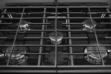 Modern built-in gas cooktop. Gas oven hob with gas burners and grate kitchen stove. Black Gas cooker