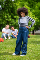 Obraz premium Smiling curly-haired african american teen looking happy