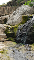 Fototapeta na wymiar Water flow. Mountain stream of water. Water spring. Cascade waterfall. Waterfalls
