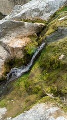 Water flow. Mountain stream of water. Water spring. Cascade waterfall. Waterfalls