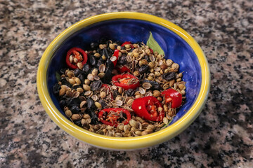 A small bowl full with spices 