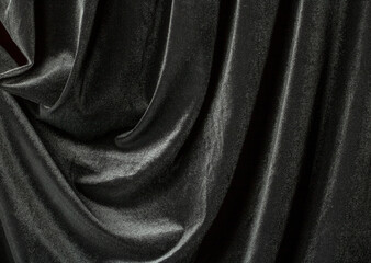 Black background of velvet fabric with beautiful folds