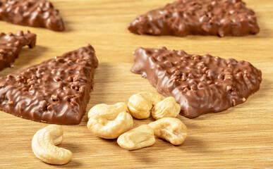 Chocolate chip cookies with nuts and cashew nuts on a wooden table