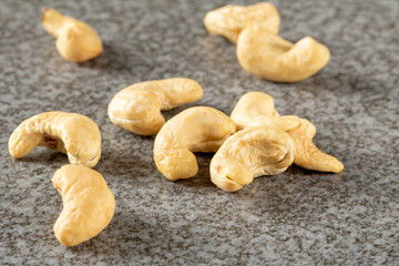 A bunch of cashew nuts on a stone stand close-up
