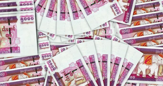 Myanmar Kyat banknotes in a cash fan mosaic pattern loop. Burma MMK 5000 money notes. Abstract concept of bank, finance, economy seamless and looped decorative design background.  