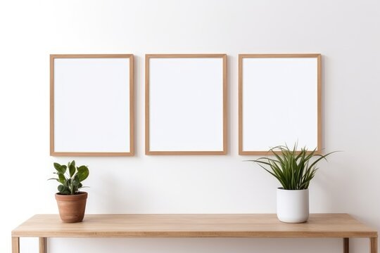 Three empty frames hang on a wall above a shelf with flowers, light brown wooden frame, portrait, mockup, generative ai