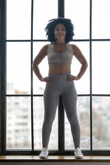 Fototapeta na wymiar Sporty young woman in grey sportwear