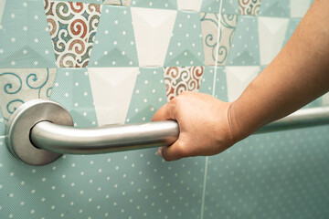 Asian elderly woman use bathroom handle security in toilet, healthy strong medical concept.