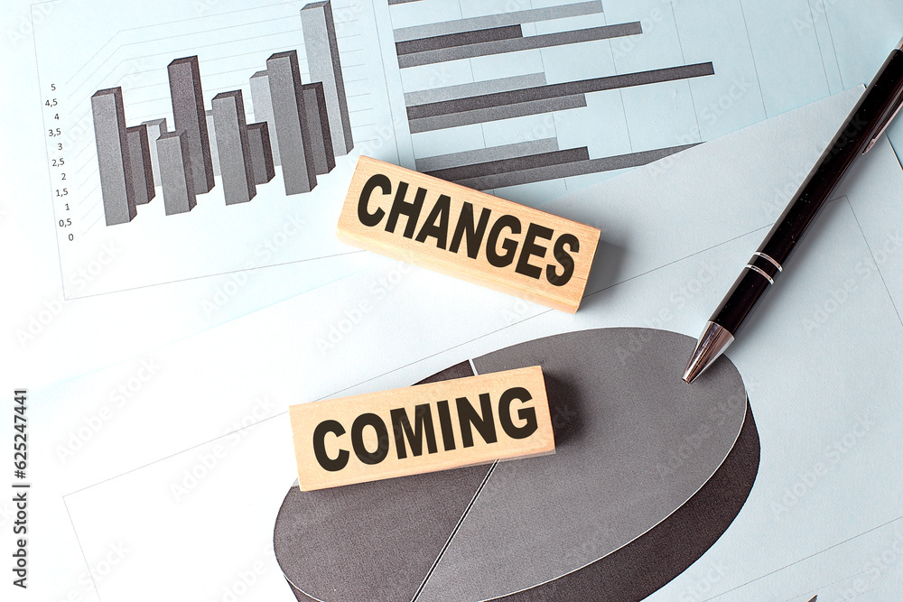 Poster changes coming text on wooden block on chart background