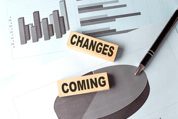 CHANGES COMING text on wooden block on chart background