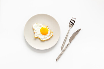 One fried egg on plate, top view. Breakfast background