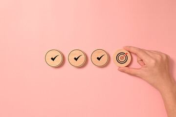 Correct checklist and target goal icons on wooden blocks, Business strategy planning and quality...