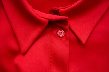 red blouse with buttons close-up, top view. Red silk shirt with buttons, classic dress with a...
