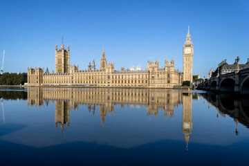 Photo of the London Parliament with the tower of Big Ben, reflected in the water of the River...