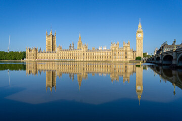 Photo of the London Parliament with the tower of Big Ben, reflected in the water of the River...