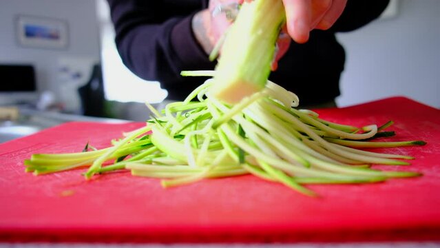 making noodles with courgette zucchini in the kitchen