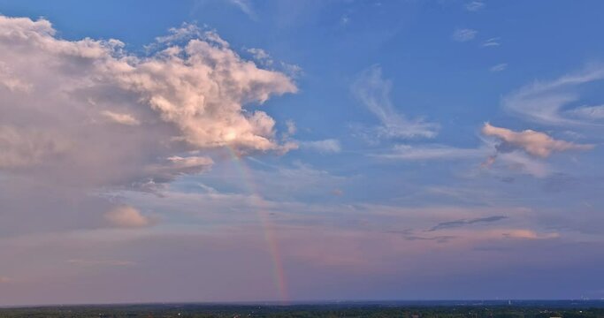 Sky transformed into mesmerizing sight as rainbow appeared after powerful thunderstorm.