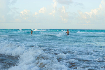Two people enjoying in the beach. Vacations in Cancun beach