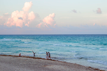 People playing and walkin in the beach sand