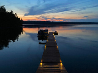 Dock at sunset with boat and dock lights