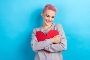 Photo of gorgeous kind candid lady wer grey trendy outfit hold red paper card celebrate valentine...