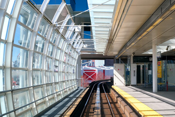 view from Sky Train window of moving train in Surrey in Vancouver spring no leaves bare trees...