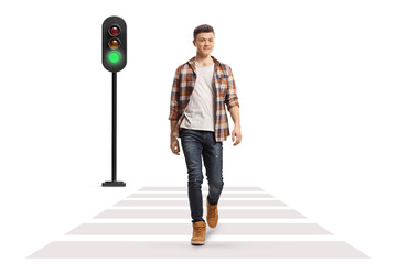 Full length portrait of a guy in jeans and checkered shirt crossing a street - obrazy, fototapety, plakaty