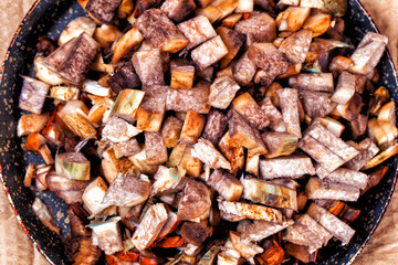 Raw chopped mushrooms in a frying pan. Close-up