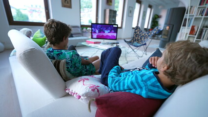 Back of children sitting on sofa watching movie entertainment