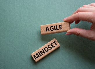 Agile Mindset symbol. Wooden blocks with words Agile MindsetAgile Mindset. Businessman hand....