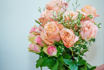 A beautiful luxurious bouquet of mixed flowers lies on the table. Wedding bouquet. Working as a florist in a flower shop