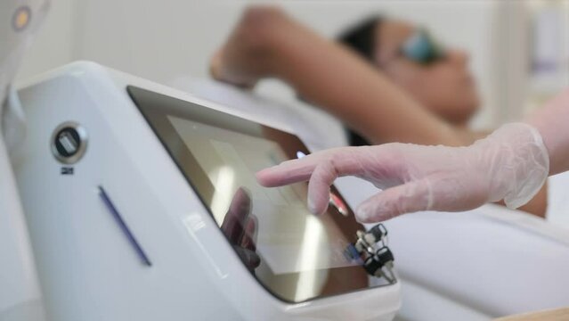 Laser epilation and cosmetology in beauty salon. Cosmetology, spa and hair removal concept. Laser hair removal procedure of female legs. doctor in gloves.