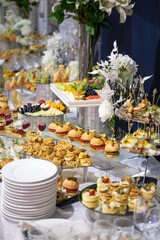 various snacks and drinks at the buffet table at the corporate catering event