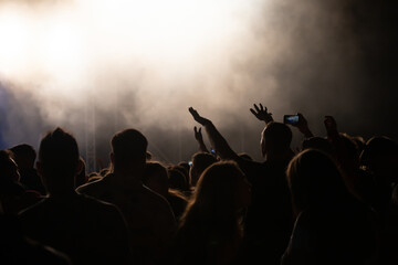 Fototapeta premium Abstract photo of crowd at concert and blurred stage lights.