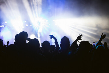 Fototapeta premium Abstract photo of crowd at concert and blurred stage lights.