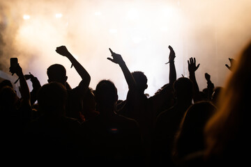 Abstract photo of crowd at concert and blurred stage lights.