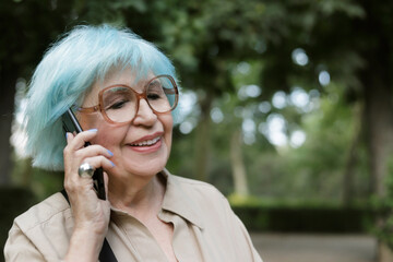 older woman outdoors talking on a cell phone