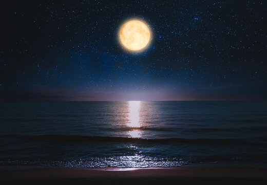 Beautiful full moon in starry sky over sea at night