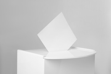 Ballot box with vote on light grey background, closeup. Election time