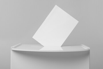 Ballot box with vote on light grey background, closeup. Election time