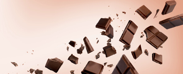 Broken chocolate bar pieces falling on pink beige background. Banner design with space for text