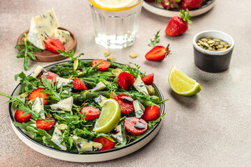 strawberry salad with asparagus, arugula, blue cheese and seeds. Delicious breakfast or snack, Clean eating, dieting, vegan food concept. top view