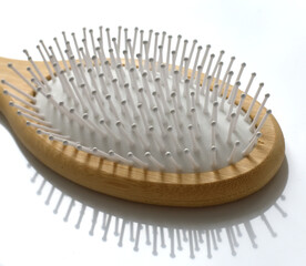 Wooden comb on white background - ecological concept