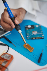 Closeup image of technician using rosin-based flux for electrical soldering